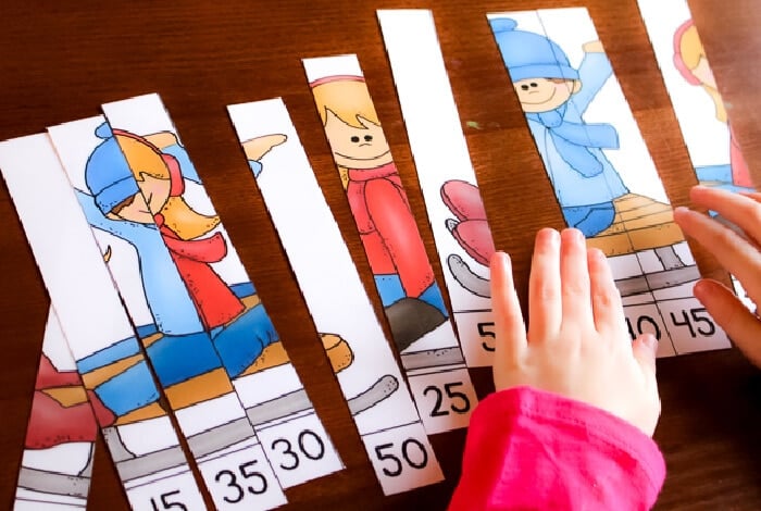 horizontal image with photo of a child putting together a disassembled skip counting by 5's puzzle