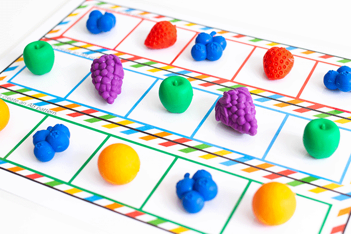 create an ab pattern independently with fruit themed pattern mats for kindergarten math centers.