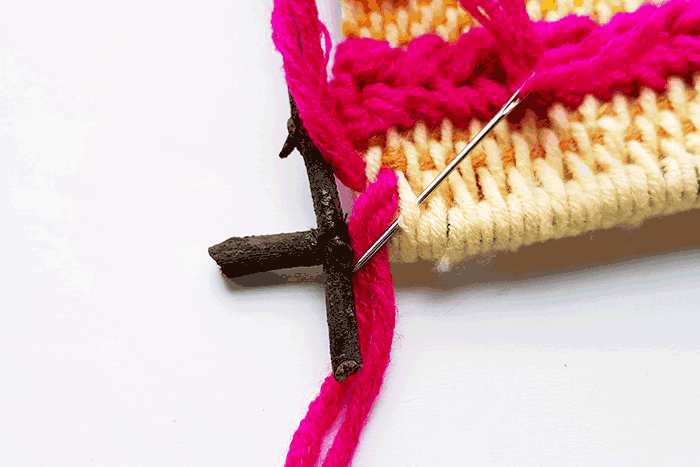 add fun to your kid weaving project by adding tassels to the bottom of your woven tapestry.