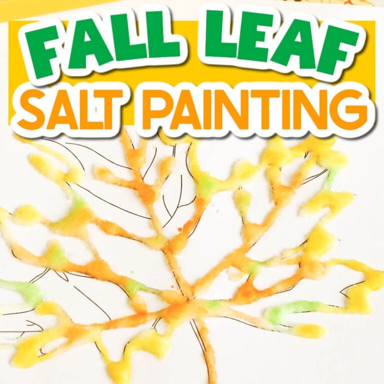 a leaf drawn on a paper traced with glue and salt and decorated with watercolors to create a fall leaf salt painting activity for preschoolers