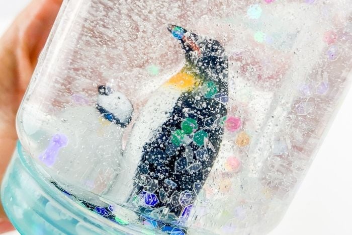 Penguins in a snow globe craft.