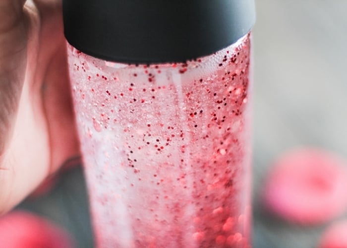 red glitter in a sensory bottle for kids.