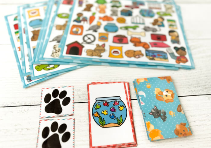 i spy game board and playing cards with colorful pet pictures.