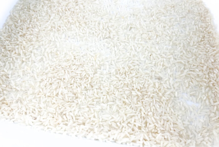 rice in the sensory bin.