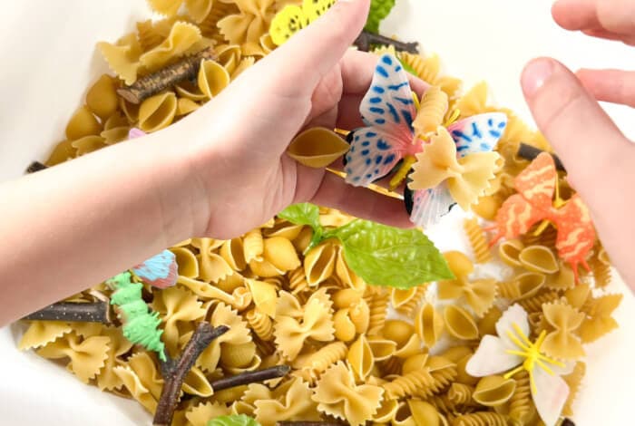 playing with items in the butterfly sensory bin.