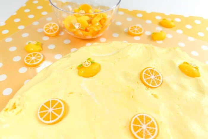 place plastic lemon toys into the cloud dough for kids to play with.