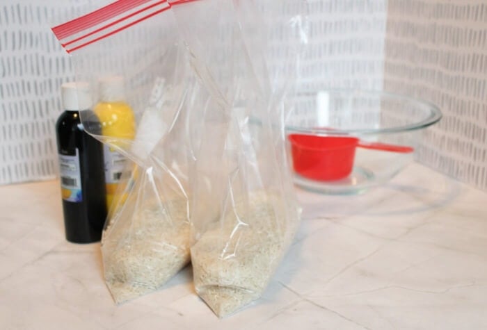 two large ziploc bags have white rice in them.