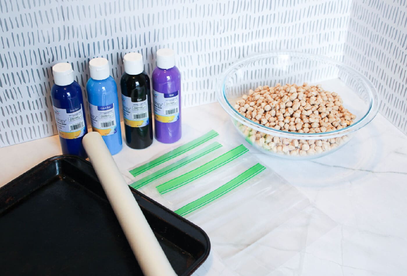 Supplies for making an outer space sensory bin with chickpeas.
