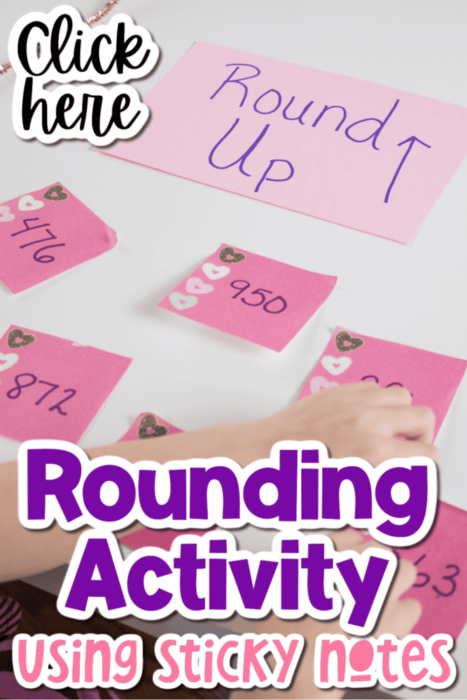 a child is placing sticky notes on a poster board for a rounding activity.