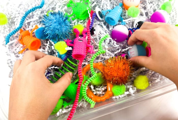 overhead shot of someone playing with a finished monster sensory bin.