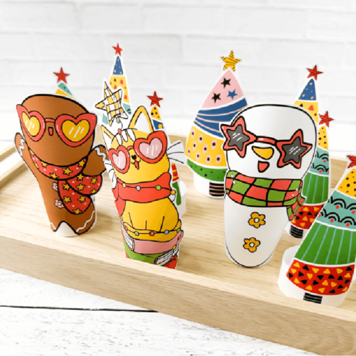 square photo of christmas paper dolls with a gingerbread man, christmas cat and snowman