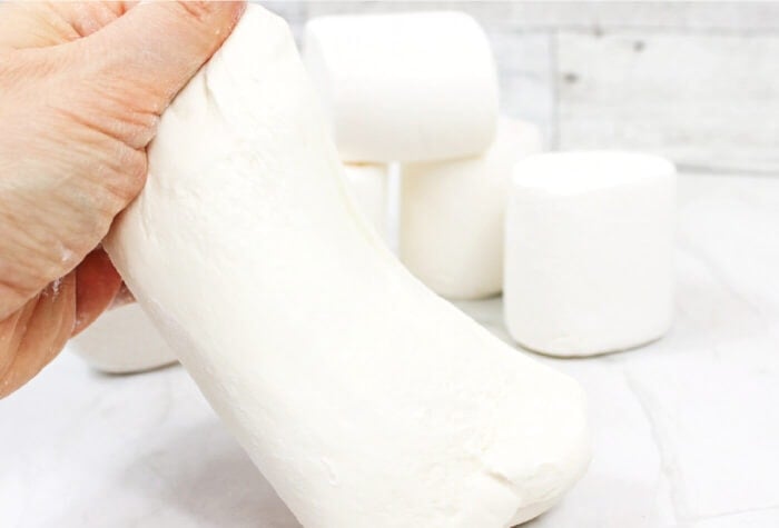 hand stretching marshmallow slime