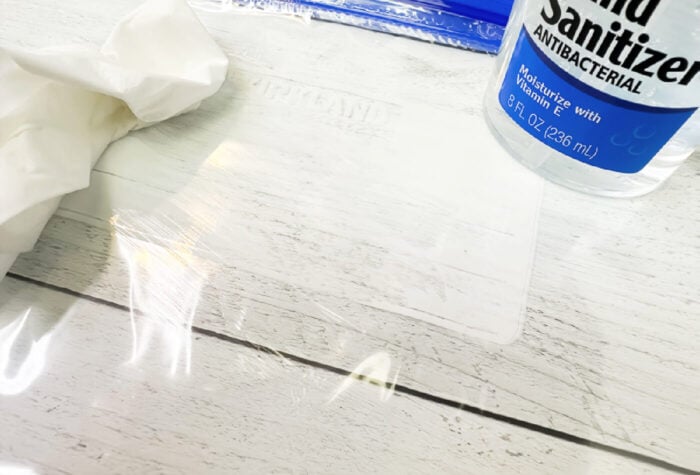 removing the label from a zip top bag by using hand sanitizer and a tissue