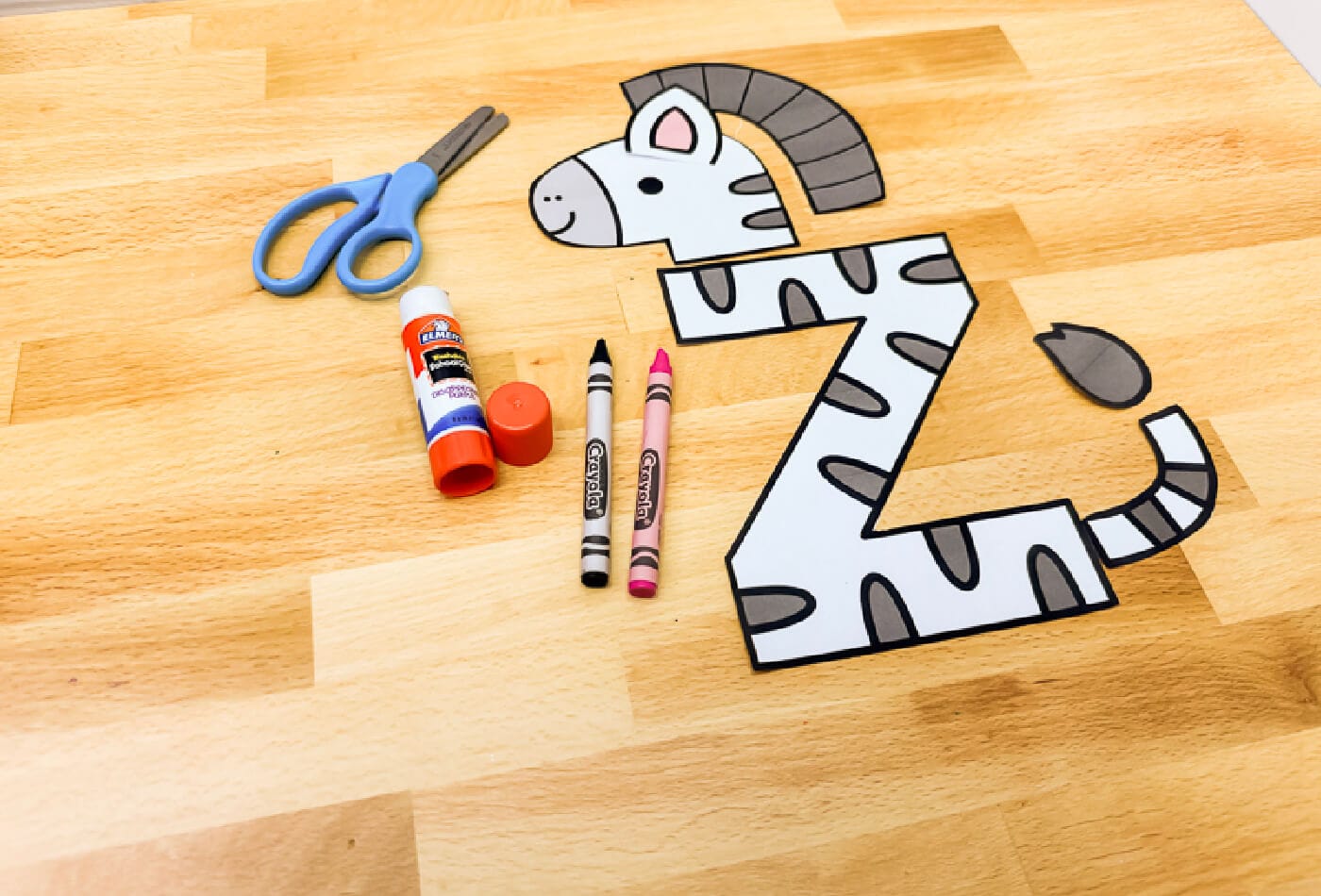 uppercase letter z zebra craft nearly complete with glued zebra head and mane. tail and ear pieces are ready to attach. preschool alphabet craft for learning the letter z.